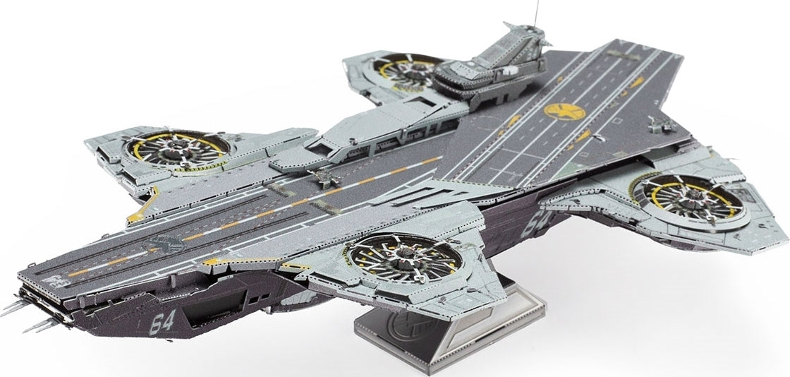 Iconx Helicarrier model kit by Fascinations, showcasing a detailed and intricate design of the helicopter aircraft carrier, complete with rotor details and a sleek, modern appearance. The model features a multicolored scheme with shades of gray and hints of yellow accents, highlighting its realistic elements and craftsmanship. Perfect for DIY enthusiasts and collectors alike.