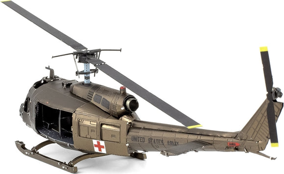 A detailed metal model of the UH-1 Huey Helicopter, showcasing realistic features such as the rotor blades, cockpit, and red cross emblem on the side. This DIY kit by Fascinations is perfect for aviation enthusiasts and model builders.