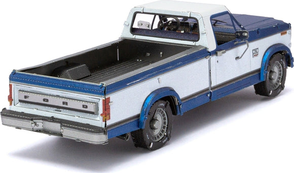 Detailed model kit of a 1982 Ford F-150 pickup truck by Fascinations. The model showcases a two-tone color scheme of white and blue with intricate detailing on the body, wheels, and interior. Perfect for DIY enthusiasts and collectors, this kit offers a rewarding building experience, capturing the essence of a classic American truck.