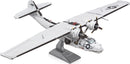 A detailed metal model of the Consolidated PBY Catalina airplane, made from intricate parts. The plane features a shiny silver finish and is displayed on a stand, showcasing its distinct wings and propellers.