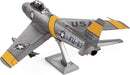 A detailed Metal Earth F-86 Sabre model kit made of metal. The model features intricate parts and a shiny metallic finish, showcasing the aircraft in a poised position. The F-86 Sabre, known for its sleek design and historical significance in aviation, includes markings of the U.S. Air Force, highlighting its design highlights and artistry.