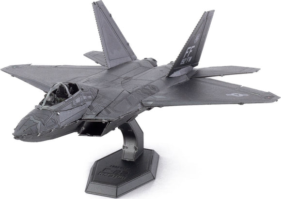 A detailed Metal Earth F-22 Raptor plane model kit from Fascinations, showcasing intricate metal craftsmanship and assembly pieces. The model displays a sleek design with realistic features such as panel lines, cockpit details, and a sturdy base for display.