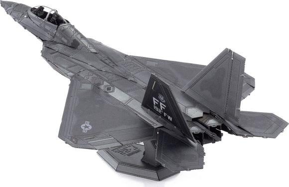 A detailed and intricately designed Metal Earth F-22 Raptor plane model by Fascinations. The DIY kit features metallic components and realistic styling, suitable for display or for model-building enthusiasts. The model showcases the iconic shape and features of the stealth fighter jet.