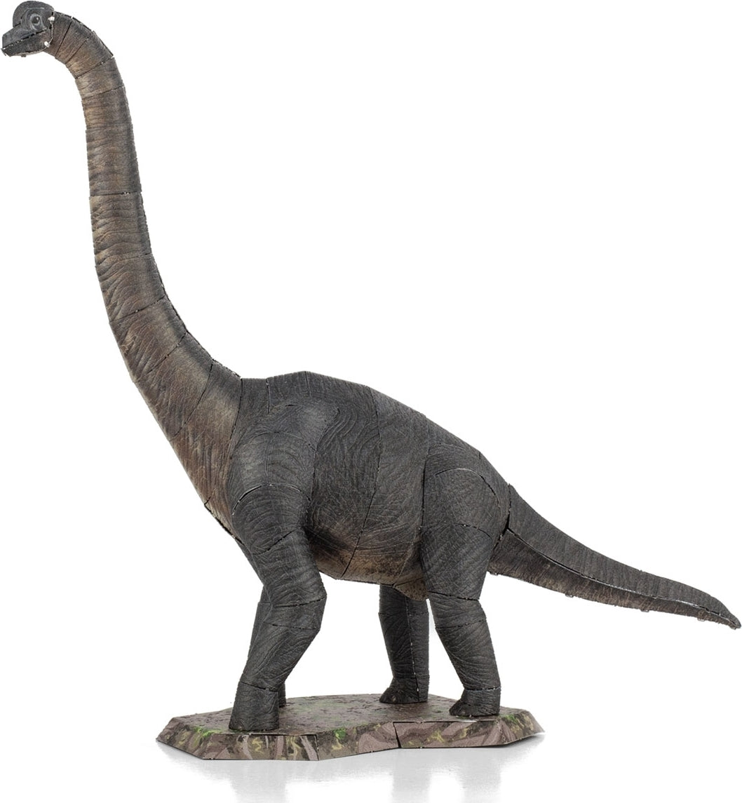 A detailed DIY metal model kit of a Brachiosaurus dinosaur by Fascinations. The model features realistic textures and a standing pose on a grassy base, showcasing the long neck and distinctive body shape of this herbivorous dinosaur.