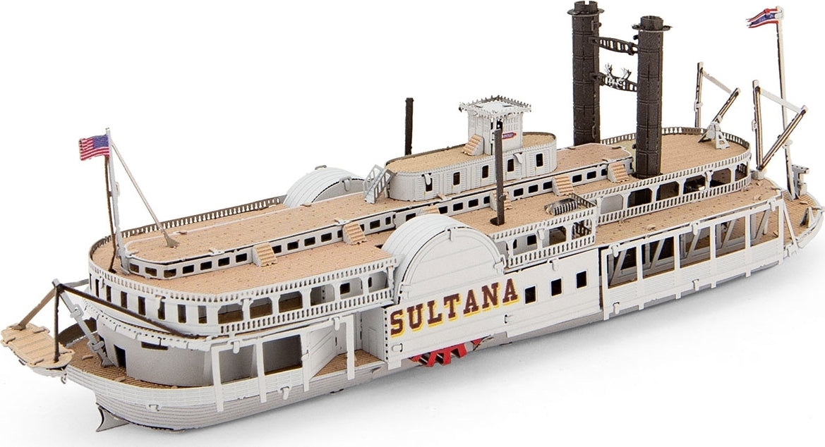 A detailed metal model of the Sultana Steamboat by Fascinations. The model features intricate elements including smokestacks, deck details, and nautical flags. Primarily white with some wooden accents, this DIY kit replicates the historic steamboat design.