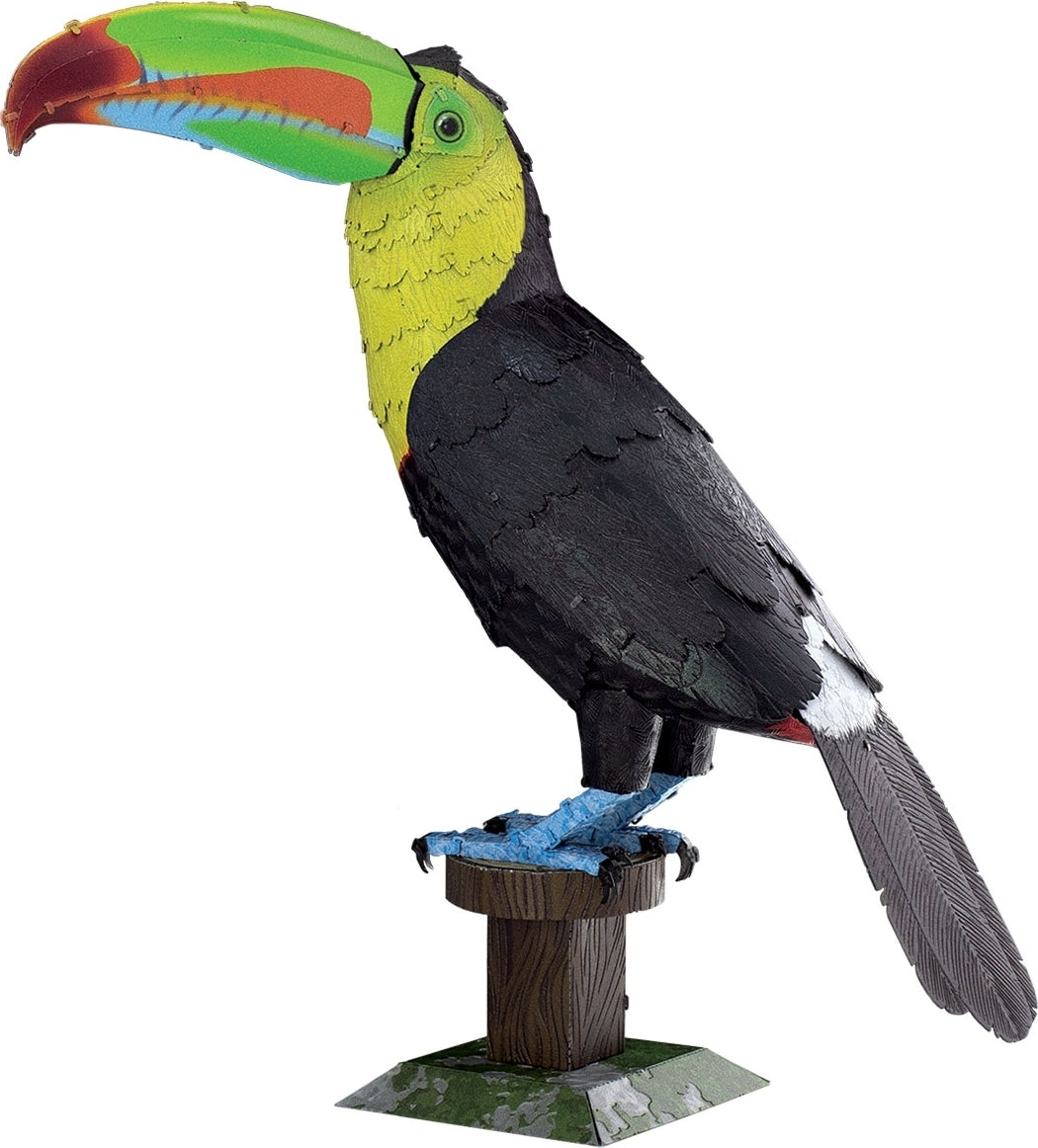 Metal Earth DIY kit featuring a colorful toucan model made from metal parts. The toucan displays vibrant colors, including a green, yellow, and black finish, and stands on a detailed wooden base, showcasing intricate metal craftsmanship perfect for enthusiasts and hobbyists.