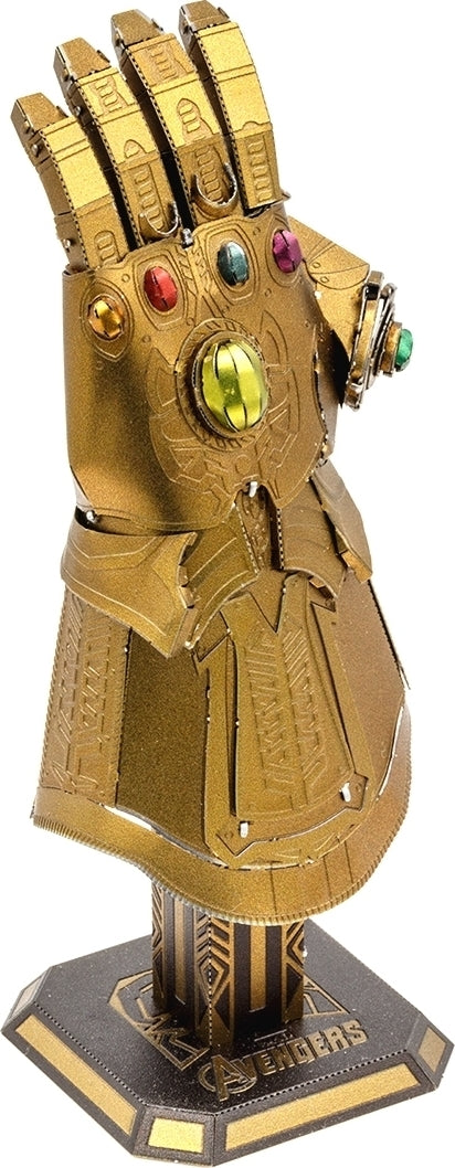 Metal Earth: Infinity Gauntlet DIY kit by Fascinations featuring intricate details and vibrant colored gems. This model depicts the iconic Marvel glove with gold finish and stands on a hexagonal base, perfect for display.