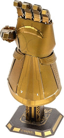 The Metal Earth Infinity Gauntlet DIY kit by Fascinations features a finely detailed metallic model of the iconic Marvel accessory. It showcases intricate designs and textures, capturing the essence of the gauntlet with its glimmering gold finish and attached Infinity Stones. Perfect for fans and collectors, this metallic sculpture is both a creative project and a striking display piece.