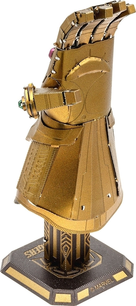 The Metal Earth Infinity Gauntlet DIY kit by Fascinations features a detailed metallic model of the iconic Marvel artifact. The gauntlet is depicted in a striking golden finish and showcases the six Infinity Stones in vibrant colors. Perfect for Marvel fans and collectors, this model offers a challenging build experience and a stunning display piece.