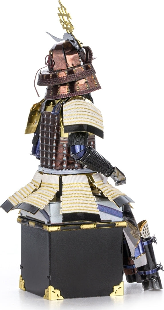 A detailed DIY kit of a Metal Earth Samurai Armor model showcasing intricate metal pieces. The model features a traditional samurai helmet adorned with a golden crest, layered armor plates, and a striking pose. The craftsmanship highlights various textures and colors, including bronze, silver, and black, suitable for hobbyists and collectors.