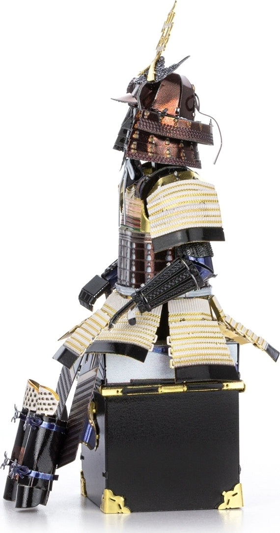 A detailed metal model of Samurai armor crafted by Fascinations. The armor features intricate designs, metallic finishes, and is posed elegantly, showcasing rich textures and a realistic silhouette. The model stands on a square base, highlighting its craftsmanship and intricate features.