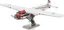 Metal Earth DIY kit featuring a detailed 3D model of the Ford Trimotor airplane. The model showcases intricate design elements including a metal fuselage, rotating propellers, and authentic markings. Perfect for aviation enthusiasts and model builders.