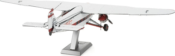 A detailed Metal Earth DIY kit of a Ford Trimotor airplane, showcasing intricate metal parts and a finely crafted design. The model is displayed on a stand, highlighting its vintage features and accurate proportions.