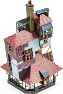 A detailed metal model of The Burrow, featuring a multi-tiered structure with intricate roofing, a chimney, and colorful windows. The kit showcases a unique design reminiscent of a whimsical house, composed of metallic pieces with various colors and textures, perfect for enthusiasts and DIY lovers.