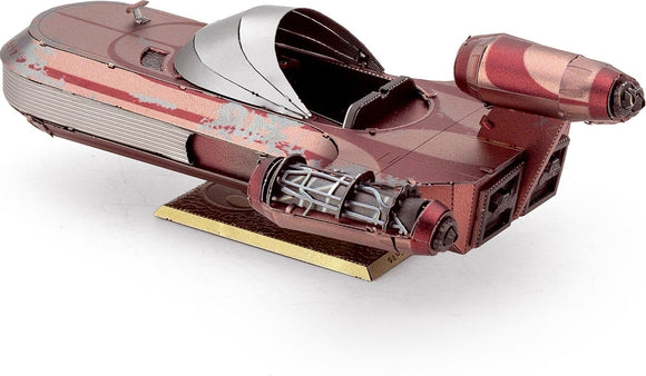 Metal Earth X-34 Landspeeder model by Fascinations. The detailed metal model features a sleek design with two large engines, a cockpit, and intricate mechanical components. The model is displayed on a textured base, showcasing its elegant craftsmanship and attention to detail.