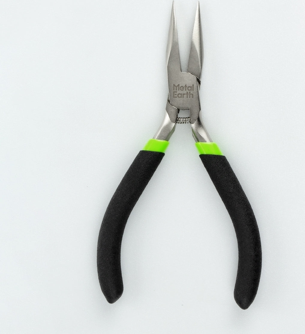 A close-up image of a high-quality pair of metal pliers, featuring rubber-coated handles in black and green for comfortable grip. The pliers are from the Metal Earth brand and designed for precision work, ideal for DIY projects and intricate tasks.