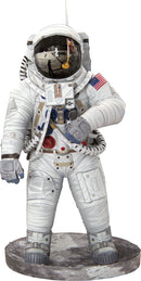 A detailed model of an Apollo 11 astronaut, showcasing intricate design elements such as the helmet's reflective visor, the American flag patch, and various equipment. The astronaut stands on a lunar-like base, embodying the spirit of space exploration.