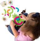 A child plays with Bugzzle, a colorful and engaging game by Fat Brain Toys. The game features a green bug-shaped base and colorful pieces, including pink, blue, and orange segments. The child is placing the pieces on the bug while reference cards are visible beside them. This hands-on activity promotes problem-solving and fine motor skills.
