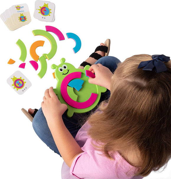 A child plays with Bugzzle, a colorful and engaging game by Fat Brain Toys. The game features a green bug-shaped base and colorful pieces, including pink, blue, and orange segments. The child is placing the pieces on the bug while reference cards are visible beside them. This hands-on activity promotes problem-solving and fine motor skills.