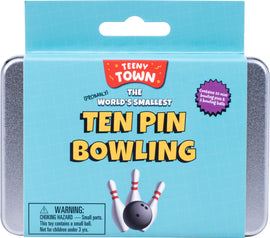 Teeny Town Bowling USA game package featuring the title 'The World's Smallest Ten Pin Bowling' with vibrant graphics. The packaging shows ten mini bowling pins and two bowling balls, all contained within a compact, portable tin. Warning label indicates small parts and choking hazard for children under 3 years.