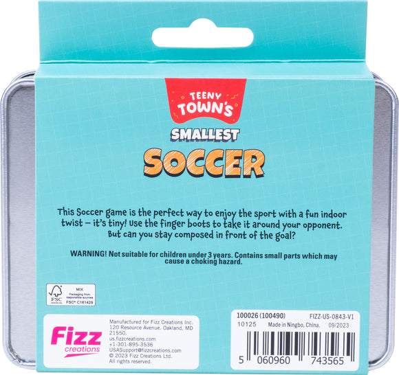 Teeny Tiny Soccer game by Fizz Creations Inc., featuring a blue tin packaging displaying the title and a description of the tiny indoor soccer game. A warning label indicates it's not suitable for children under 3 years due to small parts.