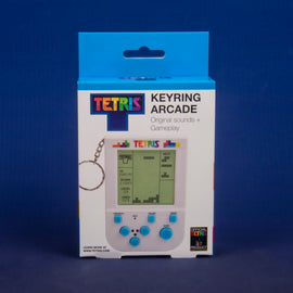 Tetris Keyring Arcade Game featuring a keychain design, showcasing a vibrant graphic with the Tetris logo, a miniature screen displaying gameplay statistics like score, level, and lines, and control buttons underneath. The product is packaged in a colorful box with original sounds and gameplay, ideal for gaming enthusiasts.