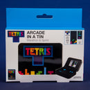 Tetris Arcade In A Tin by Fizz Creations Inc. features a vibrant, colorful design showcasing the iconic Tetris logo. The packaging includes the title 'Marathon & Sprint' with a visual of the game screen displaying gameplay elements. The compact tin design suggests a portable gaming experience, perfect for both solo and group play. The product is officially branded and offers a nostalgic gaming adventure.