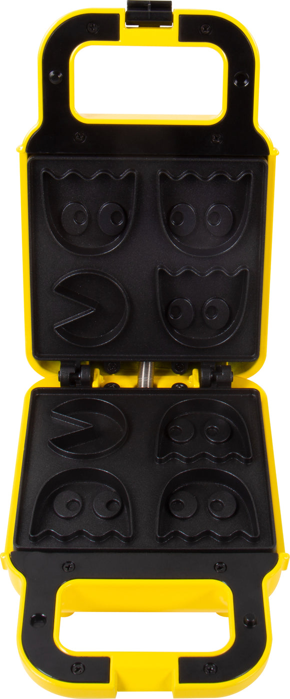 A vibrant yellow Pac Man Waffle Maker with a fun design featuring molds for iconic Pac Man characters, including the ghost shapes. The waffle maker is open, showing the intricate non-stick molds, perfect for creating deliciously themed waffles that appeal to fans of all ages.