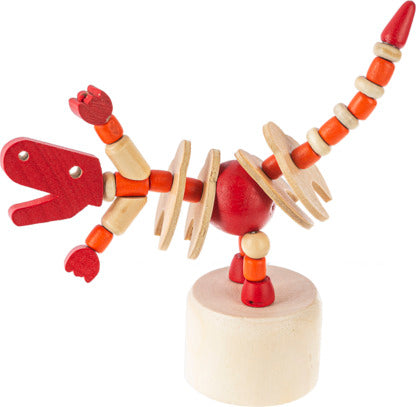 A colorful wooden dinosaur push puppet featuring a red and orange design. The puppet has articulated segments allowing it to move, with a sturdy wooden base. Ideal for imaginative play.