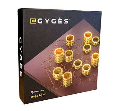 Gyges abstract strategy game box cover.  Brown board etched with circles with gold ring pieces on a black background