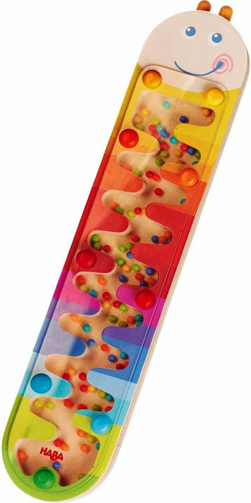 The Rainmaker Wormy by Haba is a colorful, tactile toy featuring a smiley face on top. It has a clear track with small colorful balls that roll through twisty pathways, designed for sensory play and fine motor skills development.