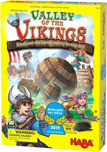 The Valley of the Vikings game by Haba features vibrant illustrations of Viking characters in action. The box displays a boy in a Viking helmet and a girl throwing coins, with barrels and Viking ships in the background. A warning about choking hazards is also included.
