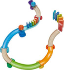 The Kubu Ball Track Kringel Domino by HABA features a colorful winding track made of wooden pieces and vibrant dominoes. The design allows for the placement of balls that roll along the curves, interacting with the dominoes to create a captivating chain reaction. Perfect for encouraging creativity and fine motor skills in children, this DIY kit provides endless possibilities for fun and learning.