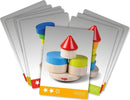 The Stacking Game Wobbly Tower by Haba features colorful wooden pieces including circles, squares, and a cone-shaped top. Ideal for developing fine motor skills and hand-eye coordination, the game challenges players to carefully stack pieces to avoid toppling the tower. Fun and educational for children.