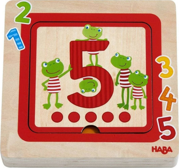 Wooden Counting Friends puzzle by HABA featuring colorful, cheerful frogs arranged around the number 5 with numbers 1 through 5 displayed. Ideal for teaching counting and number recognition.
