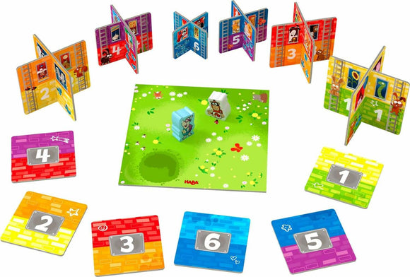 Rhino Hero Junior game by HABA featuring colorful folding cards, two playful characters, and numbered challenge tiles set on a vibrant green game board with flowers. Ideal for young players to develop skills in balance and strategy.