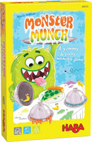 Monster Munch board game by Haba, featuring a colorful box with a playful green monster holding a silver platter of yucky food items. The vibrant design includes snails, gooey dishes, and fun fonts. Suitable for ages 5 to 99 for 2 to 4 players.