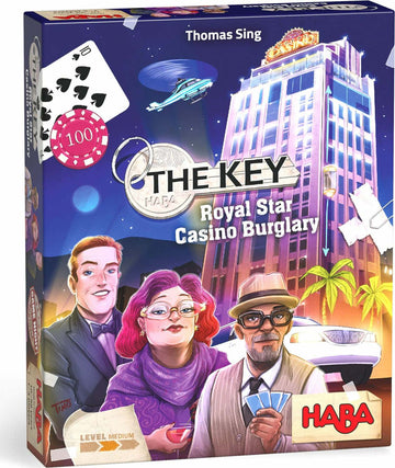The Key Royal Star Casino game by Haba features a vibrant game box showcasing characters in a casino setting, including a woman with glasses and colorful hair, a man in a tuxedo, and another man in a hat holding playing cards. The background depicts a casino building with a helicopter flying above and casino chips and cards, indicating a fun and strategic game experience.