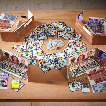 The Key Royal Star Casino by Haba is a strategic board game displayed on a wooden table. The game includes various colorful cards and tokens arranged in a circular fashion, with game boxes and components surrounding them. Players can see characters and different colored squares on the cards, promoting interaction and engaging gameplay.