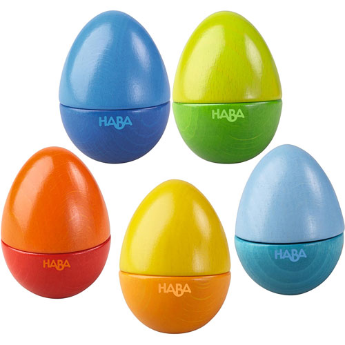 A colorful set of five musical eggs by HABA, featuring vibrant hues of blue, green, orange, yellow, and red. Each egg is designed for interactive play, producing sounds when shaken, crafted from high-quality wood for durability and tactile engagement.