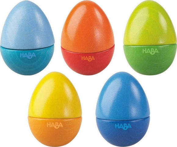 A colorful set of five musical eggs by HABA, designed for engaging play. The eggs are in vibrant shades of blue, orange, green, yellow, and red, made from durable wood, featuring smooth surfaces. Each egg can be opened, inviting exploration and sensory fun.