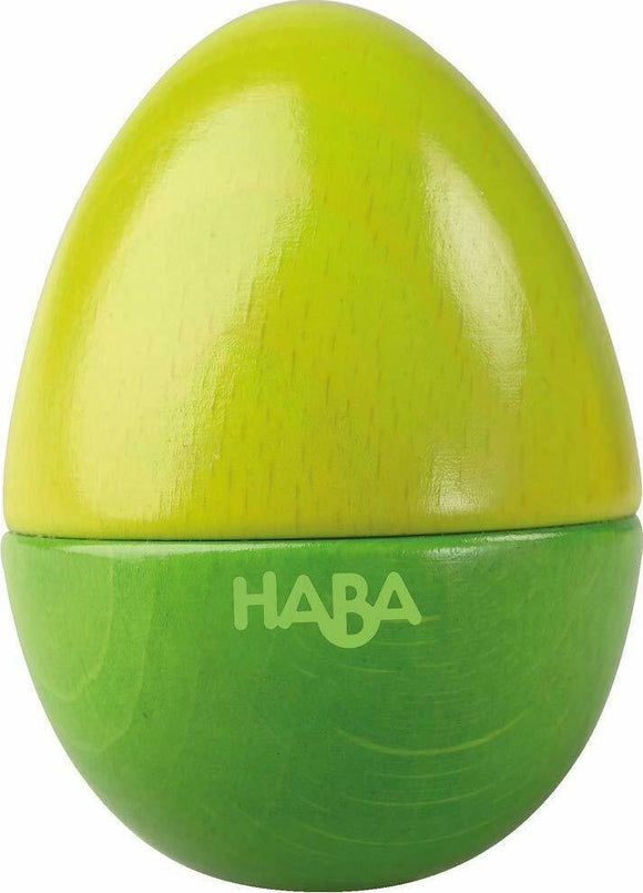 A colorful wooden toy egg from HABA, featuring a bright yellow top and a vibrant green bottom. The egg is designed for children and promotes sensory play, encouraging exploration and creativity.