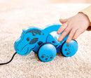 child touching blue hippo toy on carpet