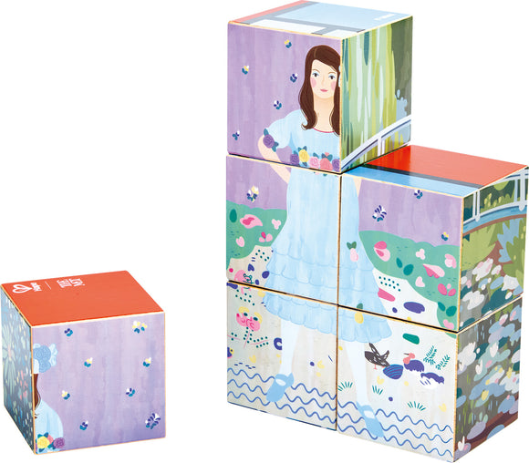 6 cubes stacked to depict a girl in a blue dress surrounded by flowers and birds