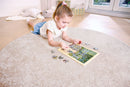 child assembling jigsaw puzzle