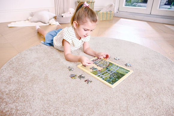 child assembling jigsaw puzzle