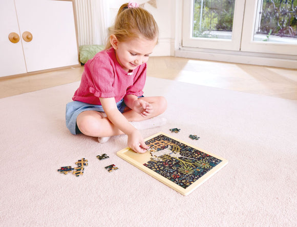 child assembling unicorn puzzle