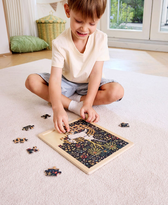 child assembling unicorn puzzle
