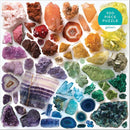 A colorful 500-piece jigsaw puzzle featuring a variety of vibrant crystals and gemstones, showcasing intricate patterns and textures across an array of colors, including purple, blue, green, orange, and yellow. Produced by Galison, this jigsaw puzzle invites creativity and relaxation while piecing together the stunning geological art.