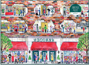 A vibrant and colorful illustration of a bookstore scene, depicting people browsing books, attending an author event, children in a story time area, and various sections labeled as Children's Books, History, Art, Poetry, Used Books, and Science. The artwork features detailed storefronts and lively interactions among customers, capturing the essence of a bustling bookstore environment.